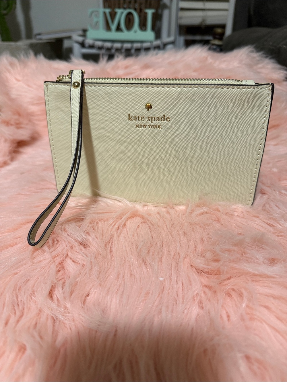 kate spade cream wristlet clutch with gold logo